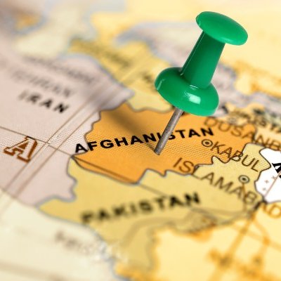 Thumbtack stuck on Afghanistan on world map.